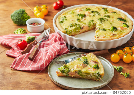 Homemade quiche with red fish, salmon, broccoli and cheese on wooden background Homemade quiche with red fish, salmon, broccoli and cheese on wooden background 84762060