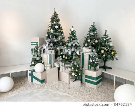 Beautiful christmas tree with decoration and gift boxes set in white living room 84762154