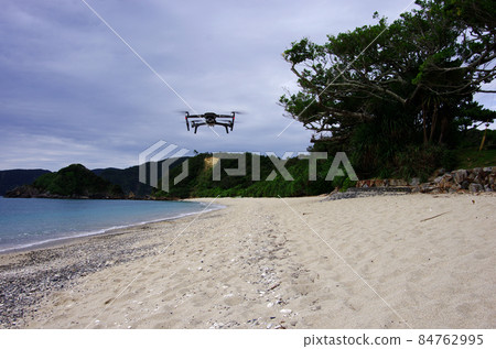 Flying a drone on an empty Yadori beach 84762995