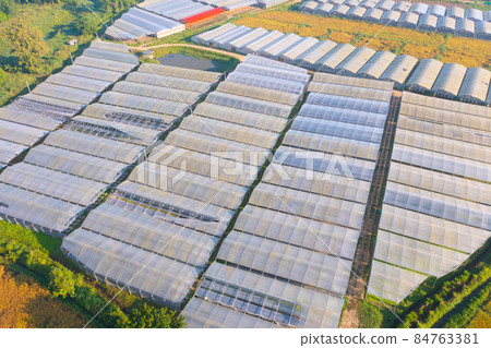 Aerial top view of roof of garden plant industry farm in agriculture concept with paddy rice field. Hydroponic natural food. Crops. Nature landscape background. Aerial top view of roof of garden plant industry farm in agriculture concept with paddy rice field. Hydroponic natural food. Crops. Nature landscape background. 84763381