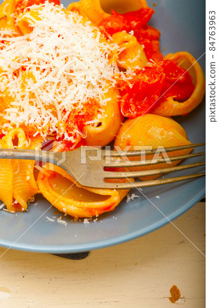 Italian snail lumaconi pasta with tomatoes 84763963