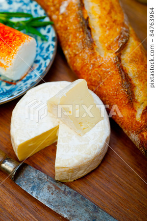 French cheese and fresh  baguette on a wood cutter 84763964