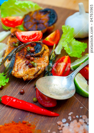 wood fired hoven cooked chicken breast on wood board 84763965