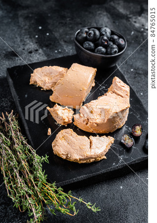 Foie gras duck liver pate and fresh blueberry. Black background. Top view 84765015