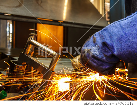 Metal in a factory grinding with sparks 84765112