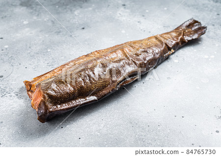 Hot smoked rainbow river trout headless. Gray background. Top view Hot smoked rainbow river trout headless. Gray background. Top view 84765730