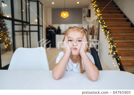 Adorable little girl looking at the camera close-up 84765905