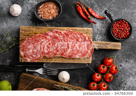 Meat antipasto, pancetta, salami, sliced ham prosciutto, on black dark stone table background, top view flat lay Meat antipasto, pancetta, salami, sliced ham prosciutto, on black dark stone table background, top view flat lay 84766309