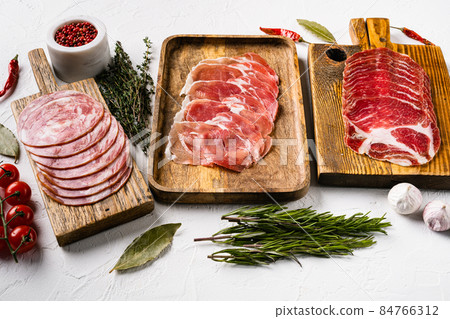 Italian sliced cured sausage , on white stone table background Italian sliced cured sausage , on white stone table background 84766312