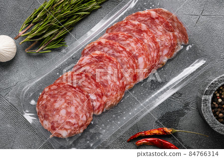 Smoked pork salami chorizo sausage pack, on gray stone table background, top view flat lay 84766314