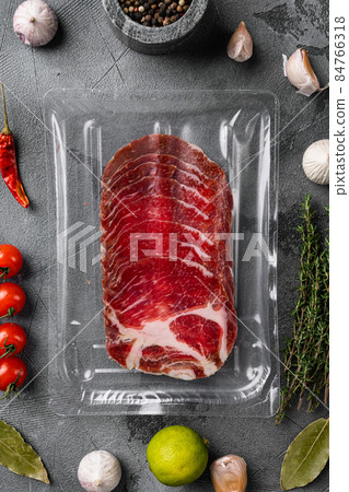 Cured meat coppa pack, on gray stone table background, top view flat lay Cured meat coppa pack, on gray stone table background, top view flat lay 84766318