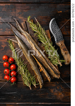Grilled lamprey , on old dark wooden table background, top view flat lay Grilled lamprey , on old dark wooden table background, top view flat lay 84766322