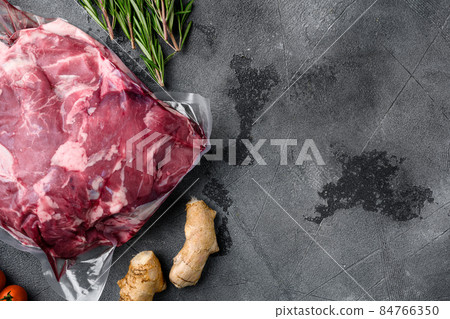 Lamb meat raw pack, with ingredients and herbs, on gray stone table background, top view flat lay, with copy space for text Lamb meat raw pack, with ingredients and herbs, on gray stone table background, top view flat lay, with copy space for text 84766350