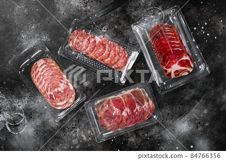 Italian sausage vacuum pack, on black dark stone table background, top view flat lay, with copy space for text Italian sausage vacuum pack, on black dark stone table background, top view flat lay, with copy space for text 84766356