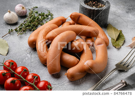 Sausages, on gray stone table background 84766478