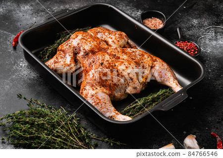Raw marinated chicken prepared in Asian style, on black dark stone table background Raw marinated chicken prepared in Asian style, on black dark stone table background 84766546
