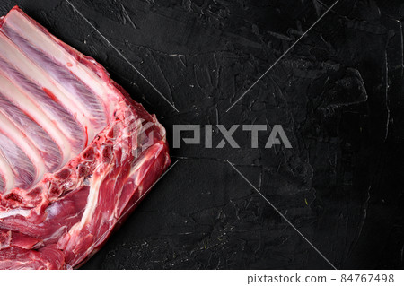 Organic lamb meat sheep or Mutton, on black dark stone table background, top view flat lay, with copy space for text 84767498