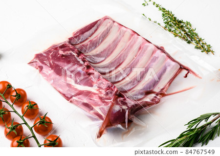 Lamb ribs cooking. Raw rack of lamb meat, on white stone table background Lamb ribs cooking. Raw rack of lamb meat, on white stone table background 84767549