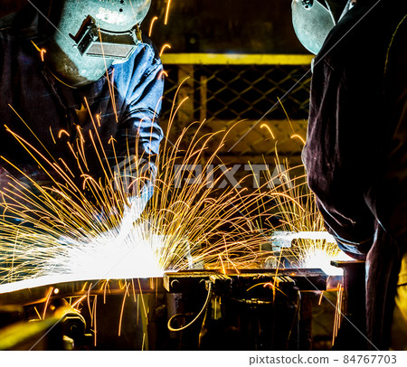 worker with protective mask welding metal 84767703