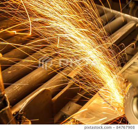 Metal in a factory grinding with sparks Metal in a factory grinding with sparks 84767908