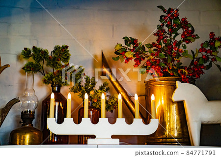 candlestick for seven electric candles on shelf with elements of Christmas decor 84771791