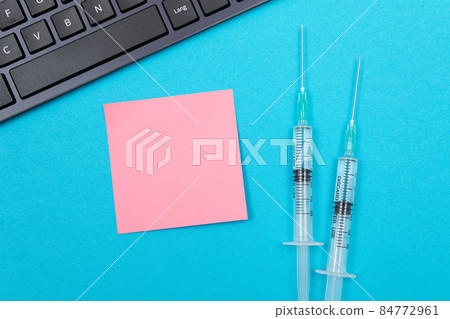Vaccination or Revaccination Concept - Two Medical Syringe on Blue Table 84772961
