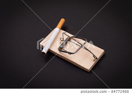 Tobacco Addiction - Cigarettes in Wooden Mousetrap Tobacco Addiction - Cigarettes in Wooden Mousetrap 84772988