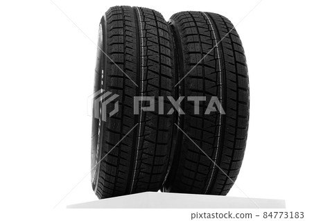 winter tires on a white wall background winter tires on a white wall background 84773183