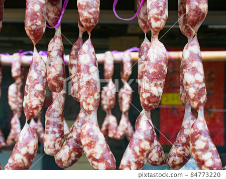 Chinese sausages hung up traditionally at a market stall. 84773220