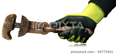 Hand with Work Glove Holding an Old Rusty Adjustable Pipe Wrench Hand with Work Glove Holding an Old Rusty Adjustable Pipe Wrench 84773602
