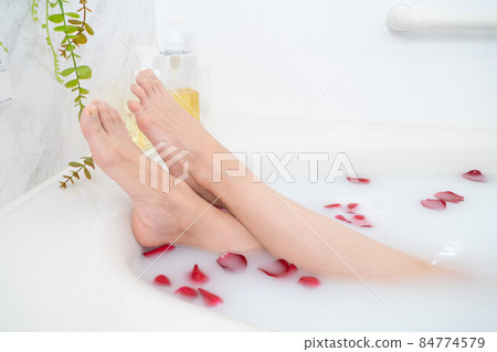 Legs of a woman taking a rose bath Legs of a woman taking a rose bath 84774579