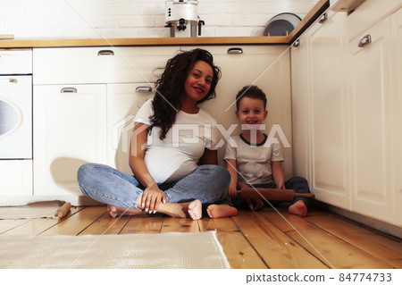 young pretty african american mother with little cute son on kitchen in morning preparing breakfast, lifestyle people concept young pretty african american mother with little cute son on kitchen in morning preparing breakfast, lifestyle people concept 84774733