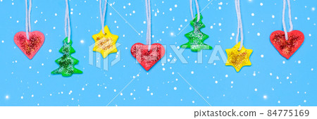 DIY Garland for Christmas tree. Fut tree, star and heart made from red, yellow and green Plasticine. Long Christmas or New Year banner. Plasticine craft concept 84775169