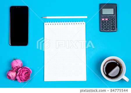 Office table desk with tablet, smartphone, calculator, flowers, coffee and white blank. Top view and copy space for text Office table desk with tablet, smartphone, calculator, flowers, coffee and white blank. Top view and copy space for text 84775544