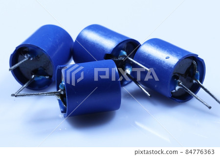 Electronic components:  ferrite inductor coil. Passive two-terminal electrical component that stores electrical energy in a magnetic field.  84776363