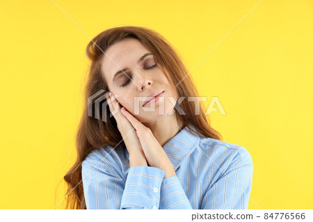 Attractive woman in shirt on yellow background 84776566