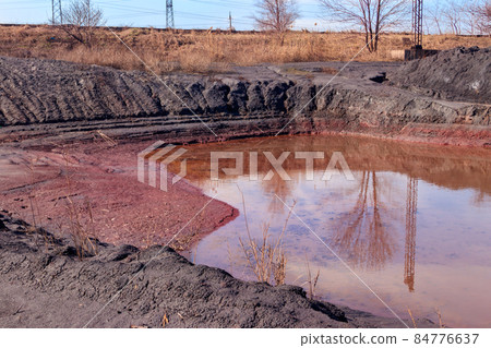 Technical settler of industrial water of mining industry in Kryvyi Rih, Ukraine. Red water polluted with iron ore waste Technical settler of industrial water of mining industry in Kryvyi Rih, Ukraine. Red water polluted with iron ore waste 84776637