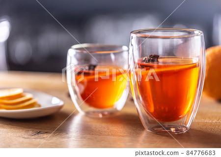 Winter drinks Hot Aperol Spritz two glass cups on a bar counter Winter drinks Hot Aperol Spritz two glass cups on a bar counter 84776683