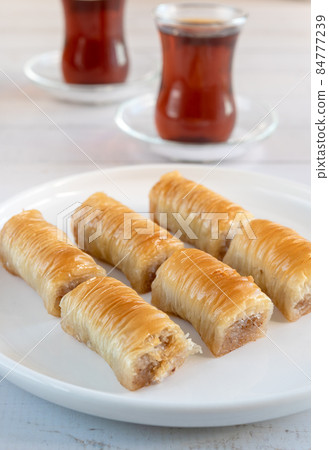Traditional Turkish baklava and a glass of tea. 84777239