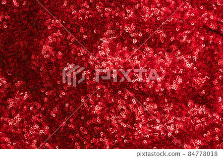 Shiny and glittering red fabric with sequins. Abstract background. Events, celebrations, Christmas, New Year. Trendy backdrop. 84778018