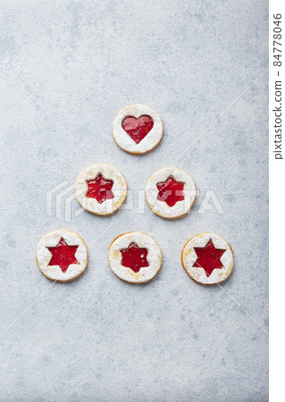 Classic Linzer Christmas Cookies with raspberry or strawberry jam on light background. Classic Linzer Christmas Cookies with raspberry or strawberry jam on light background. 84778046