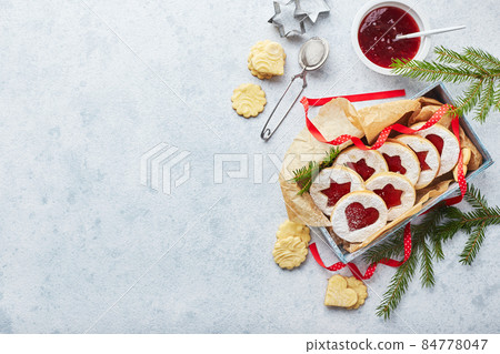 Classic Linzer Christmas Cookies with raspberry or strawberry jam on light background. Classic Linzer Christmas Cookies with raspberry or strawberry jam on light background. 84778047