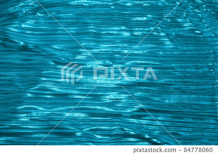 Shiny turquoise blue fabric. Abstract background. Events, celebrations, Christmas, New Year. Trendy backdrop. Shiny turquoise blue fabric. Abstract background. Events, celebrations, Christmas, New Year. Trendy backdrop. 84778060