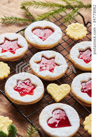Classic Linzer Christmas Cookies with raspberry or strawberry jam on wooden table Classic Linzer Christmas Cookies with raspberry or strawberry jam on wooden table 84778062