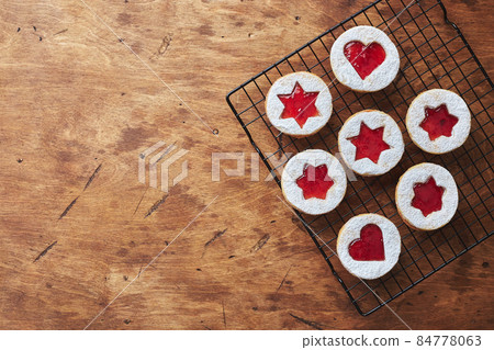 Classic Linzer Christmas Cookies with raspberry or strawberry jam on wooden table Classic Linzer Christmas Cookies with raspberry or strawberry jam on wooden table 84778063