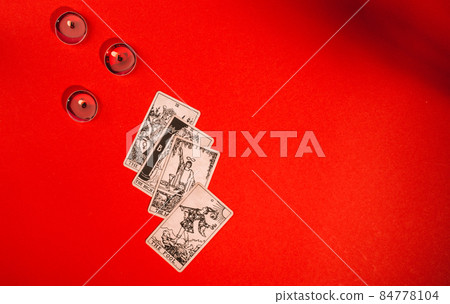 Tarot cards on red background, occult and magic 84778104