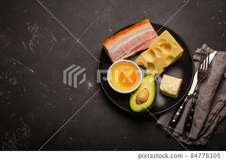 Foods for keto diet on black plate on dark background copy space 84778105