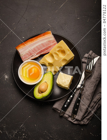 Foods for keto diet on black plate on dark background 84778122