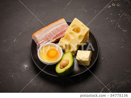 Foods for keto diet on black plate on dark background Foods for keto diet on black plate on dark background 84778136