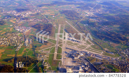 ZURICH, SWITZERLAND - 15th APRIL 2015: Aerial view of the multiple runways and terminals at Zurich international airport ZURICH, SWITZERLAND - 15th APRIL 2015: Aerial view of the multiple runways and terminals at Zurich international airport 84778328